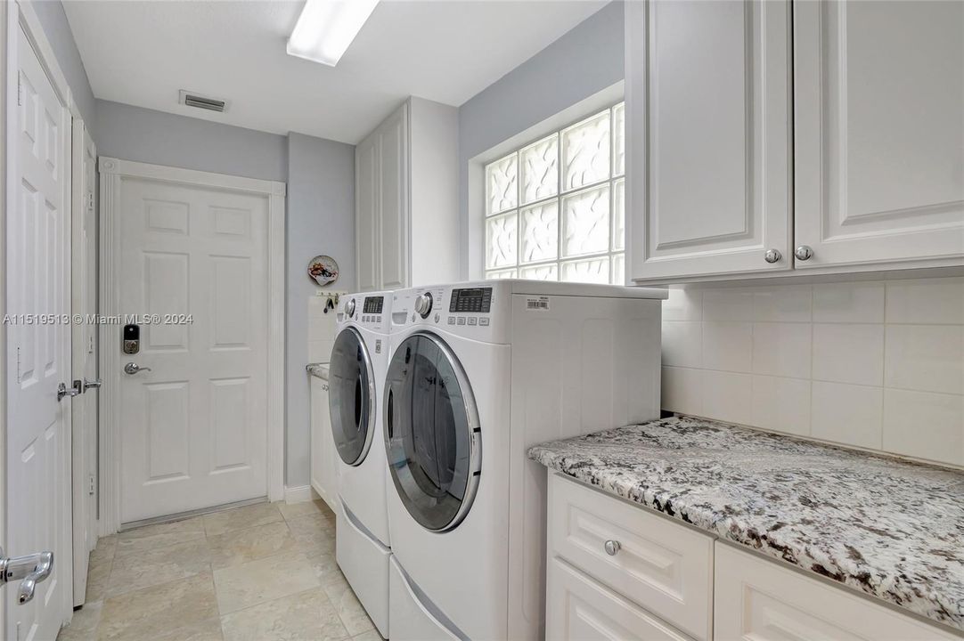 Laundry room with LG pedestal W/D, granite counters, utility sink & tons of cabinet/closet space