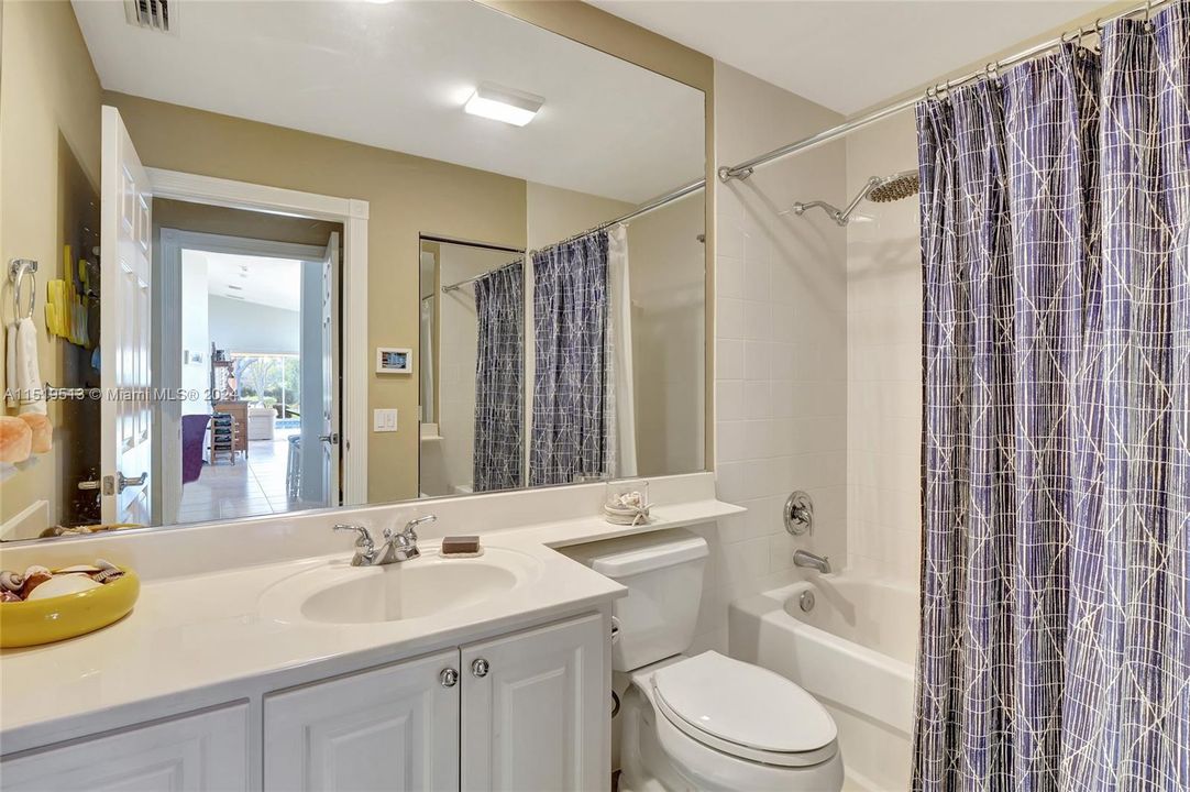 Guest bathroom ensuite to 2nd bedroom & privately located off of foyer/family room area