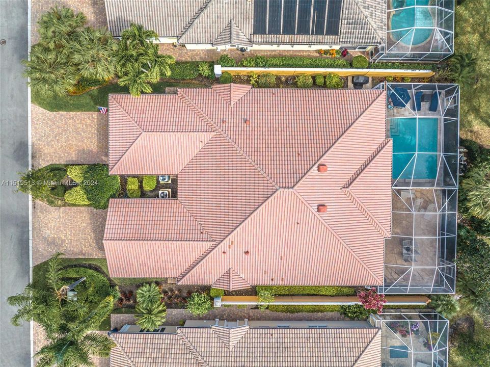 Top view of full structure & roof - Unit listed is noted by American flag & large rectangular pool