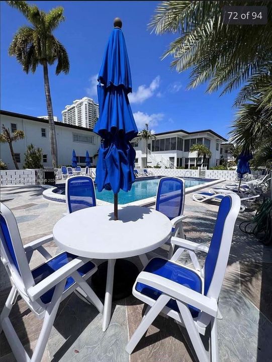 enjoy patio chair and umbrella poolside