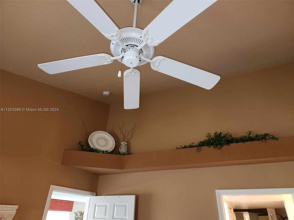 Ceiling fan and vaulted ceiling with accent shelf