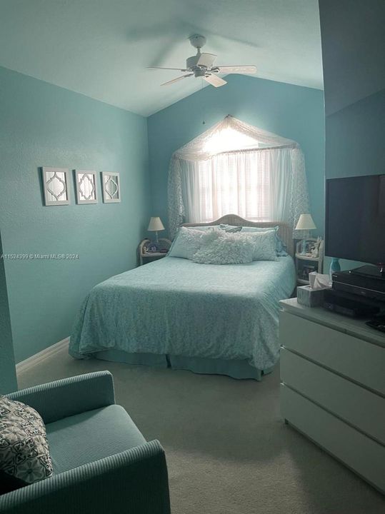 Guest room is bright and sunny with peaked ceiling