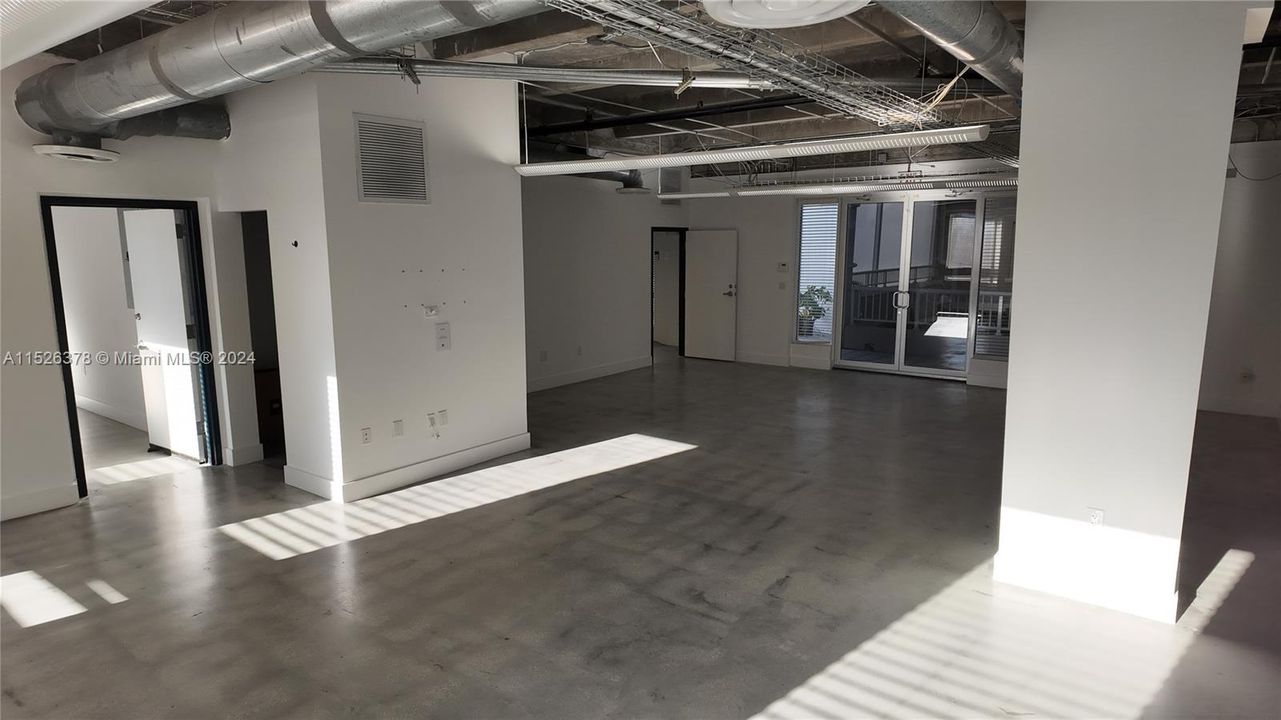 Large Open Office with polished concrete floors and exposed ceiling