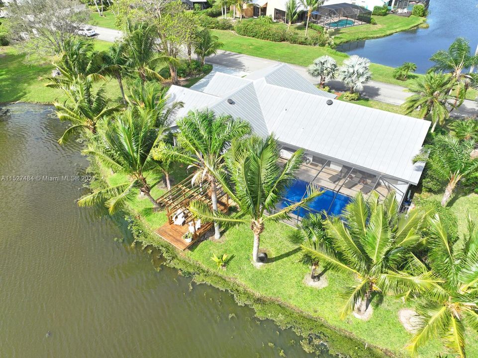 Aerial view of back, pool, dock, and lake