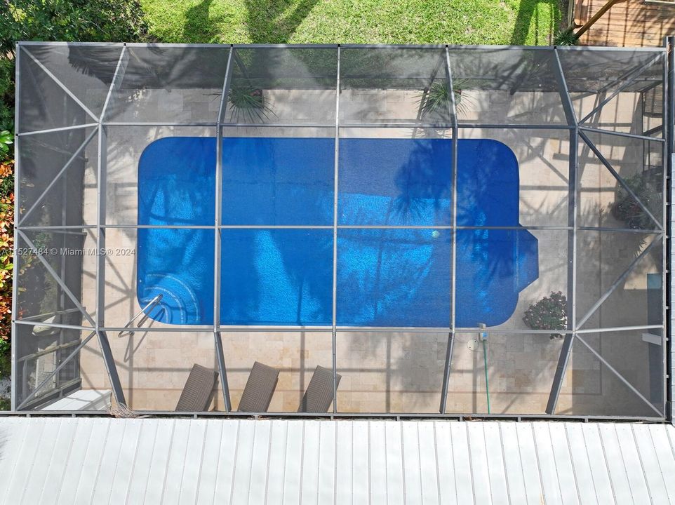 Aerial view of screened in pool and deck