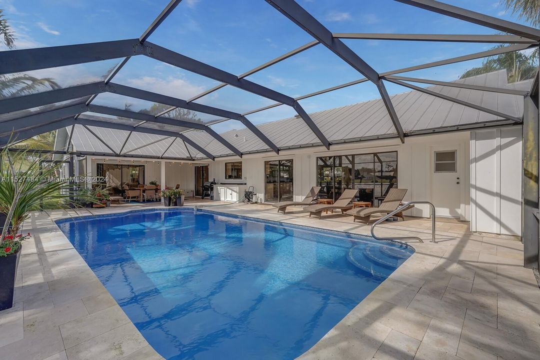 Pool area with screened in travertine deck