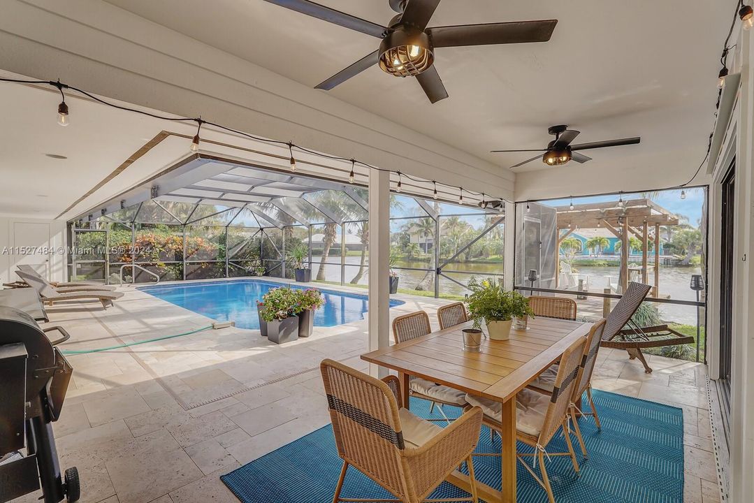 Covered, screened in patio and travertine deck