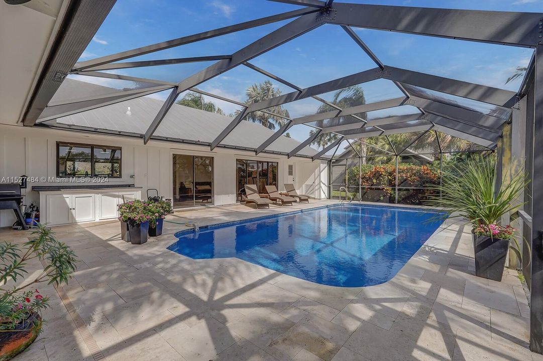 Screened in pool and travertine deck