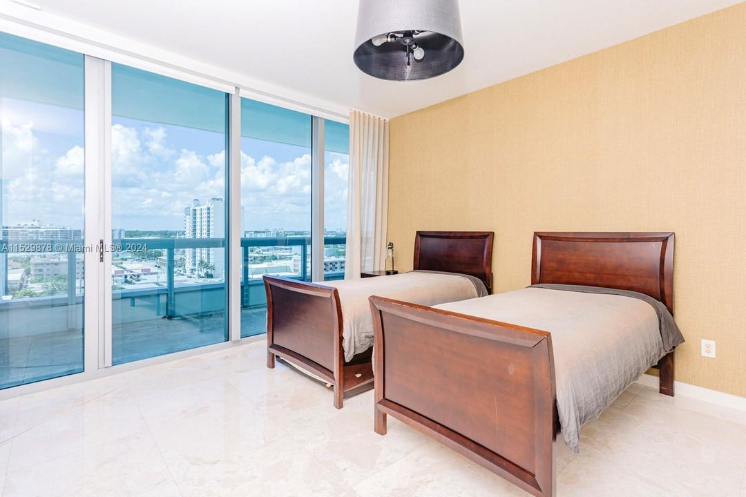 Bedroom #3 with balcony access overlooking to the pool and city.