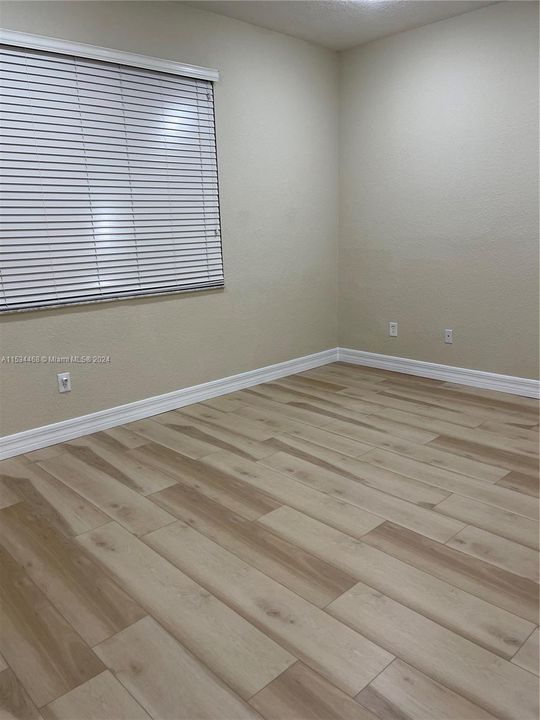Master bedroom with new flooring and walk in closet
