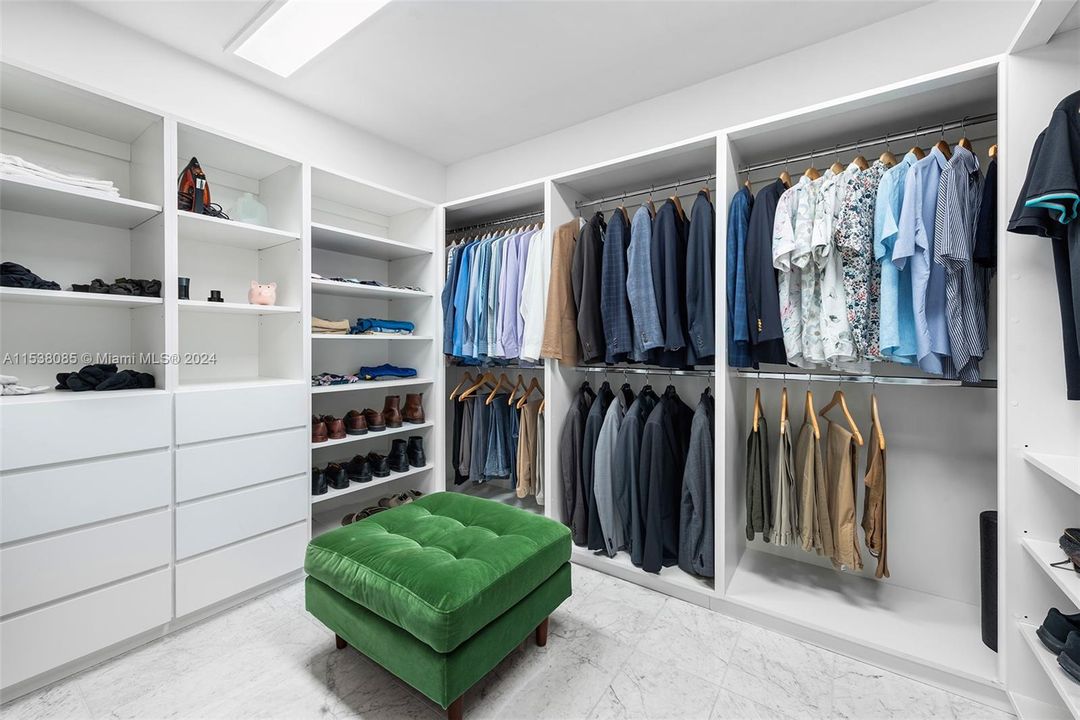 Oversized walk-in closet with custom cabinetry