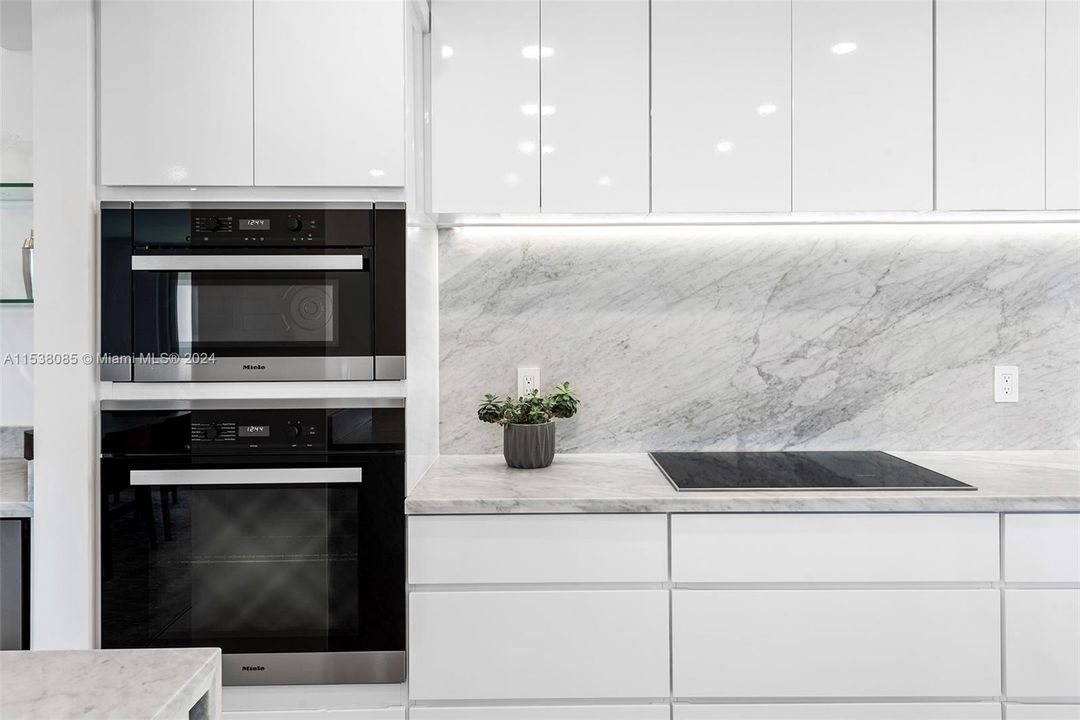 Remodeled open kitchen with Italian Carrara marble counters with 30" inch marble backsplash