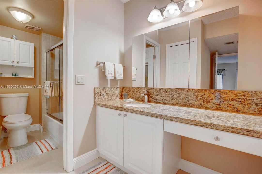 Master Bathroom Vanity Area with Granite Counter, Walk-in Closet and Linen Closet