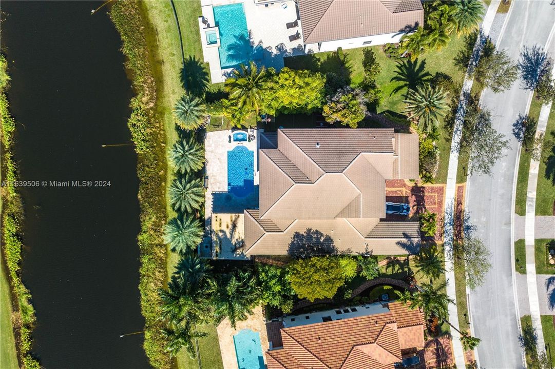 Aerial view of property above with lake view