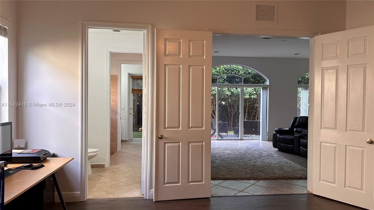 View from the master suite towards the full bath (left)...with another 1/2 bath adjacent to the cabana door.  Family Room is on the right side.