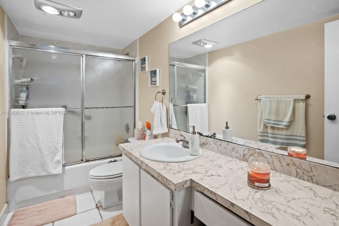 Ensuite bath has a looooong vanity and features a tub/shower combination.