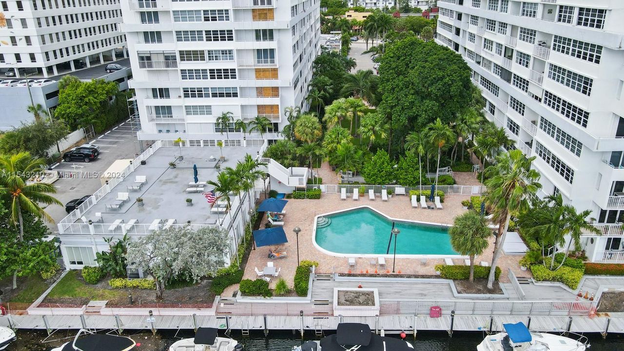 To the left of the pool and sun deck is the renovated and newly furnished community room, newly updated gym areas with separate men's and women's restrooms and sauna