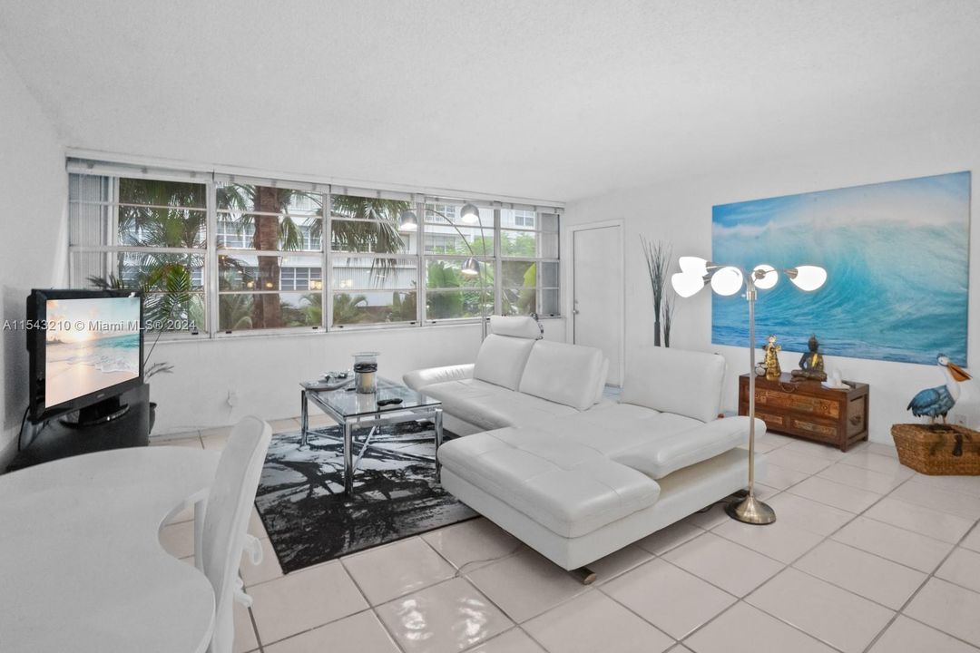 Neutral, cool, snowy white ceramic tile floors through living room and dining area.