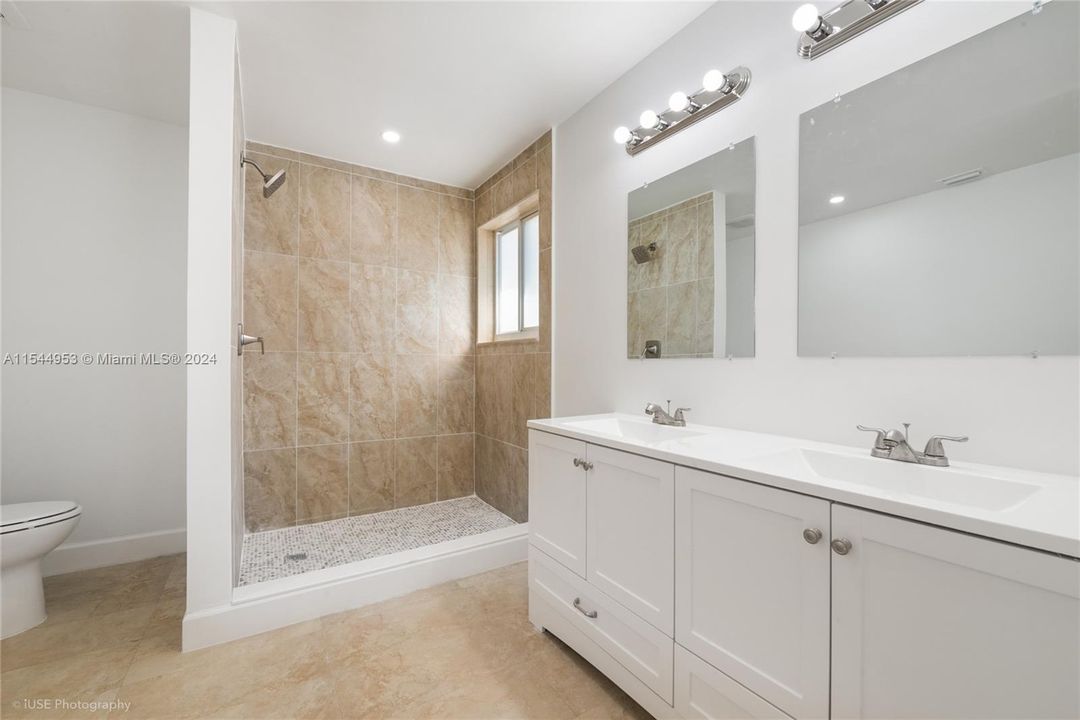 Plenty of room in this primary bathroom! Also light and airy with Brand NEW dual sink cabinetry.