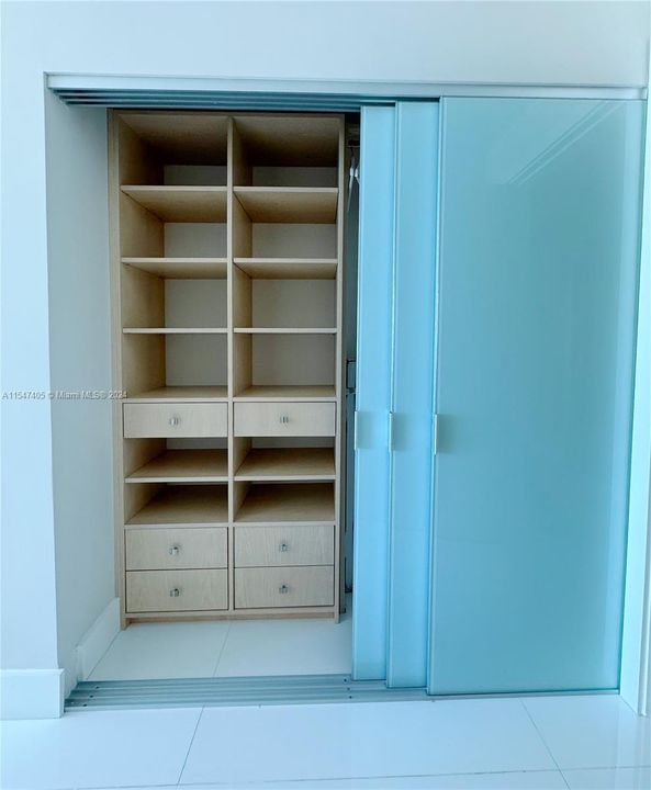 Suite 2 closet with two-side sliding doors.