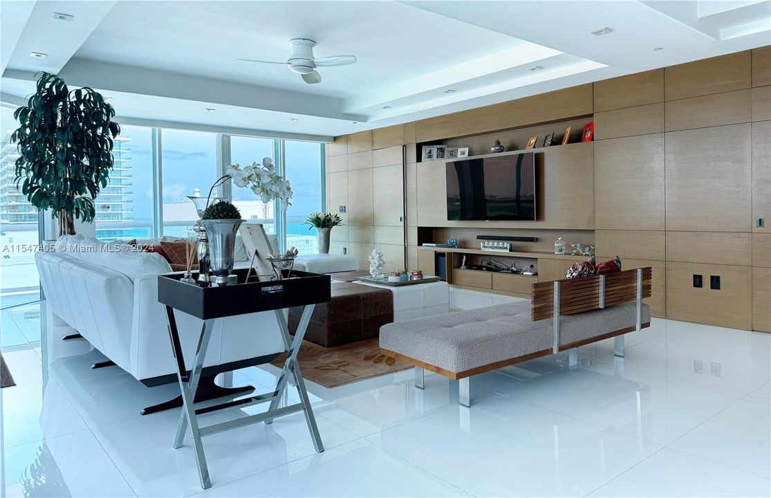 Elegant and wide living room integrated with dining and grill area.