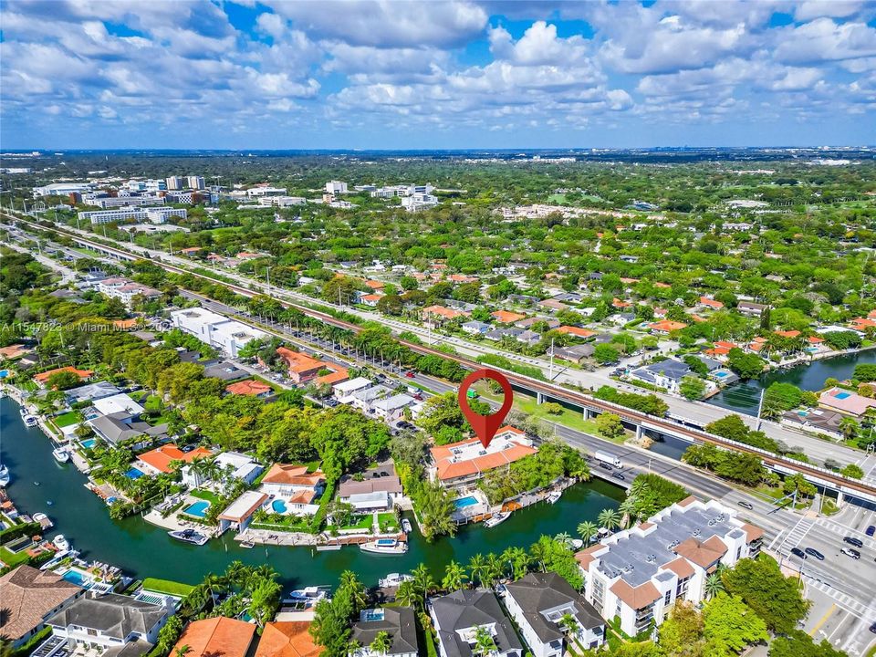 Building located by the Coral Gables Waterway, surrounded by million-dollar homes.