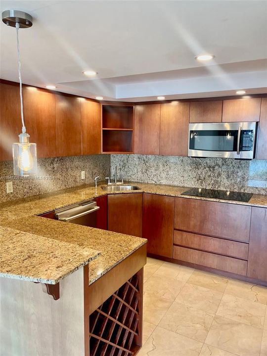 bright and open stainless steel and granite countertop w plenty of storage