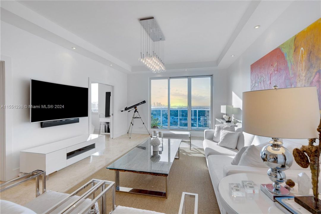 Step into this stunning living room and be greeted by a breathtaking view of the iconic Miami skyline. The floor-to-ceiling windows, complemented by the 10 ft ceilings, flood the apartment with an abundance of natural light, creating a spacious and airy atmosphere. The modern design and open layout make this the perfect space for both relaxation and entertaining, with the vibrant cityscape serving as the ultimate backdrop.