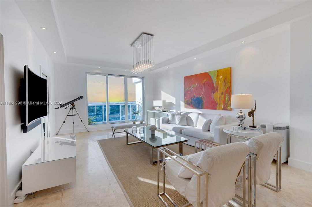 Step into this stunning living room and be greeted by a breathtaking view of the iconic Miami skyline. The floor-to-ceiling windows, complemented by the 10 ft ceilings, flood the apartment with an abundance of natural light, creating a spacious and airy atmosphere. The modern design and open layout make this the perfect space for both relaxation and entertaining, with the vibrant cityscape serving as the ultimate backdrop.