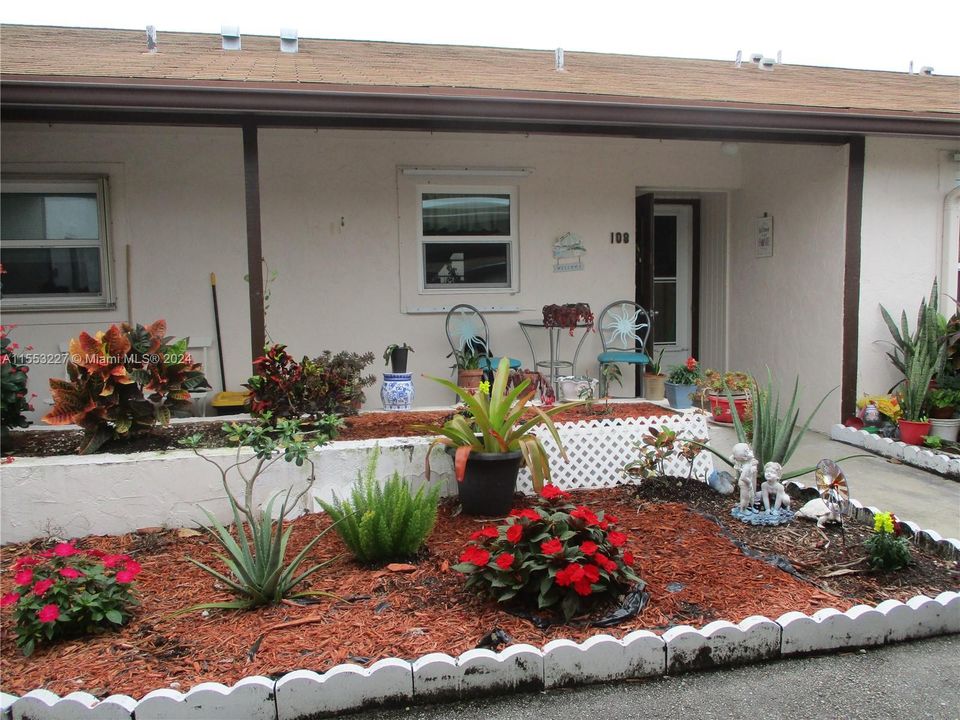 ENTRANCE INTO THE VILLA WITH COLORFUL GARDEN