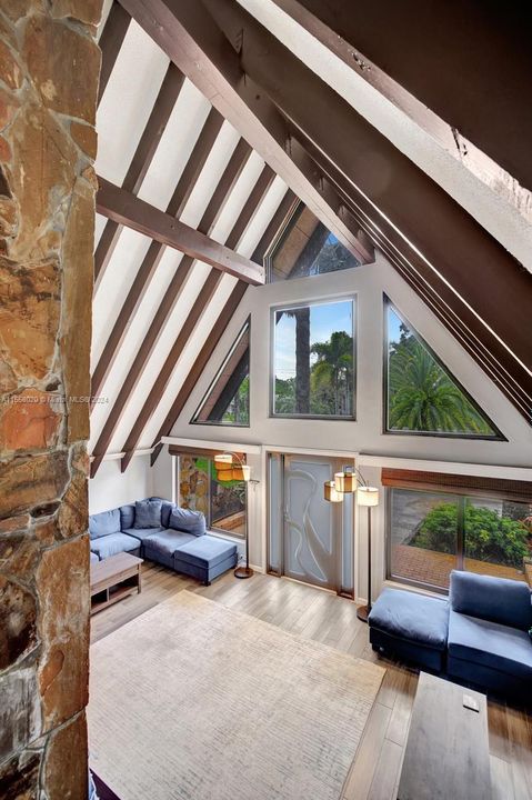 Precision-cut beams frame the interior space, highlighting the geometric beauty that A-frame homes are celebrated for.