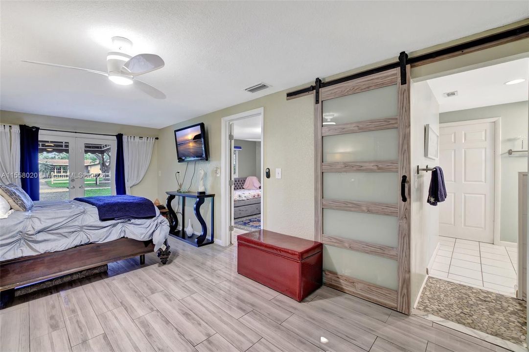 Barn door to the bathroom from the primary bedroom