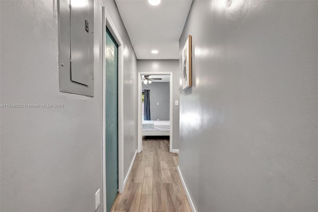 Hallway to two bedrooms down the hall from the great room. Green door on left is the large updated full guest bathroom