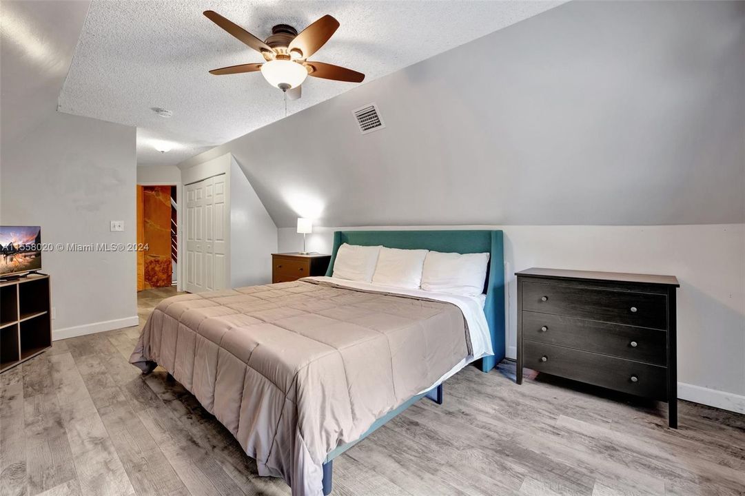 Primary bedroom upstairs w/ garden and pool view