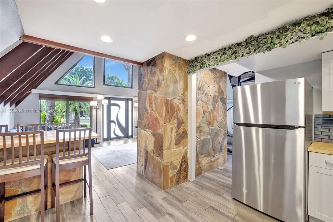 Back of the natural stone fireplace provides an artful wall in the kitchen