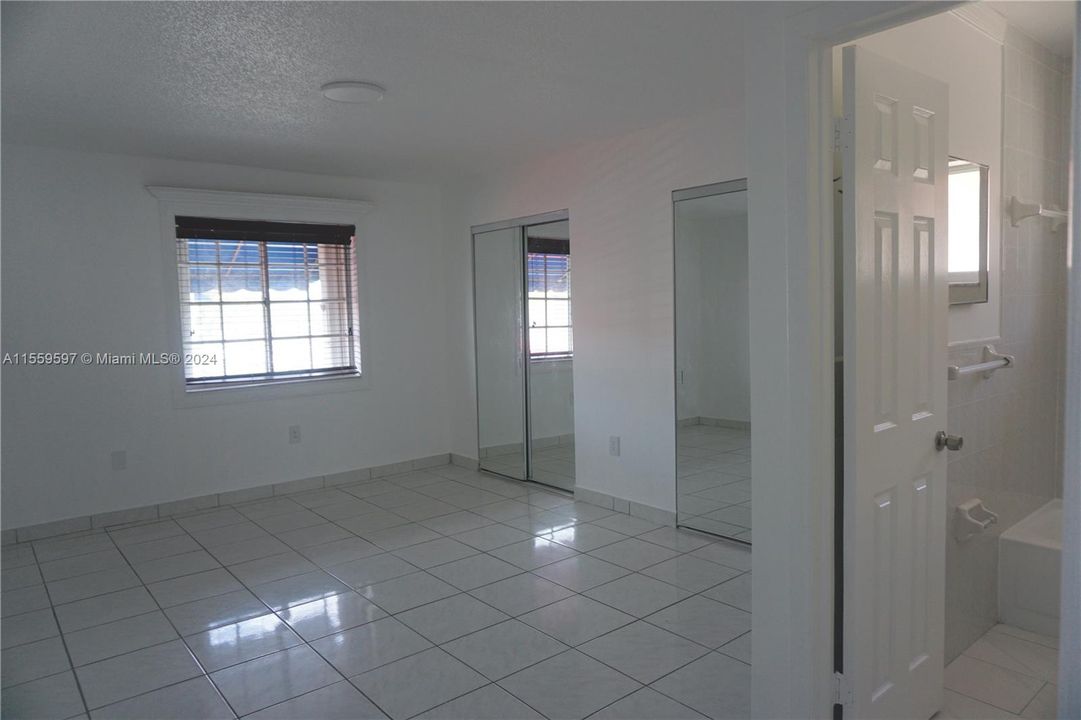 Double closets with main bathroom in photo