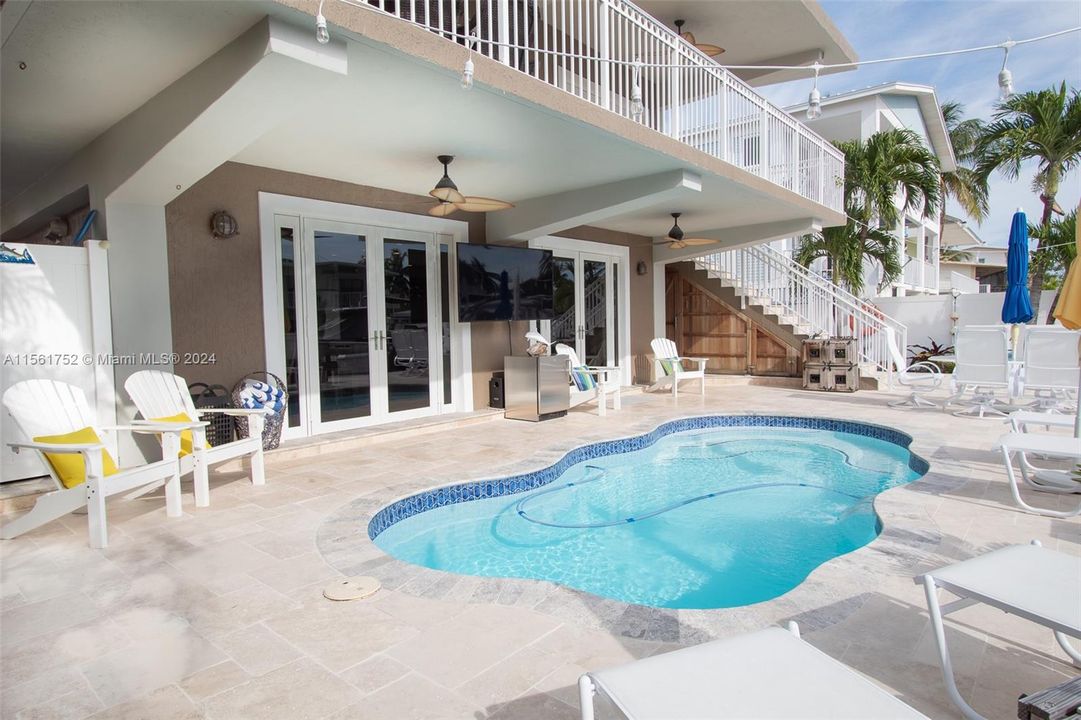 Immerse yourself in the comfort of this Key Largo retreat at 124 Bahama Road, featuring a sparkling pool with impact doors and windows ensuring a serene and secure tropical living experience