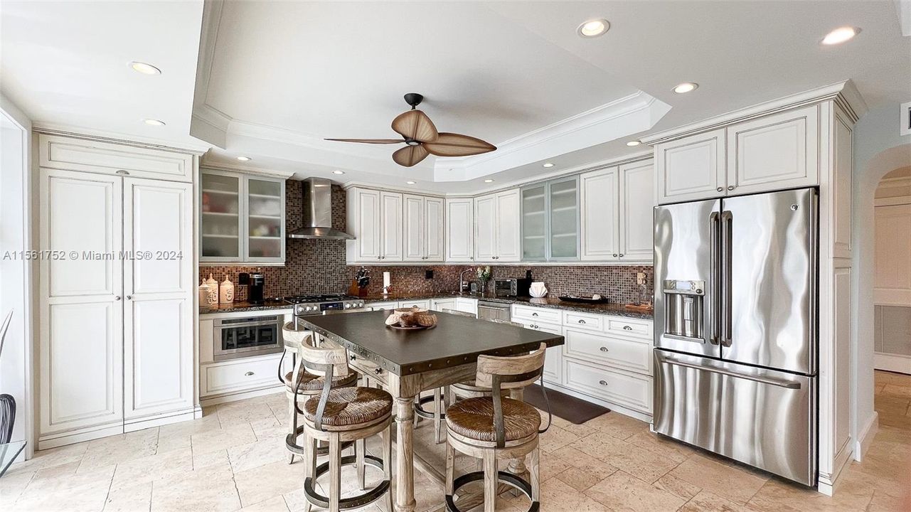 Craft culinary delights in this gourmet kitchen at 124 Bahama Road, boasting sleek stainless steel appliances, elegant white cabinetry, and a spacious island – a true chef's dream