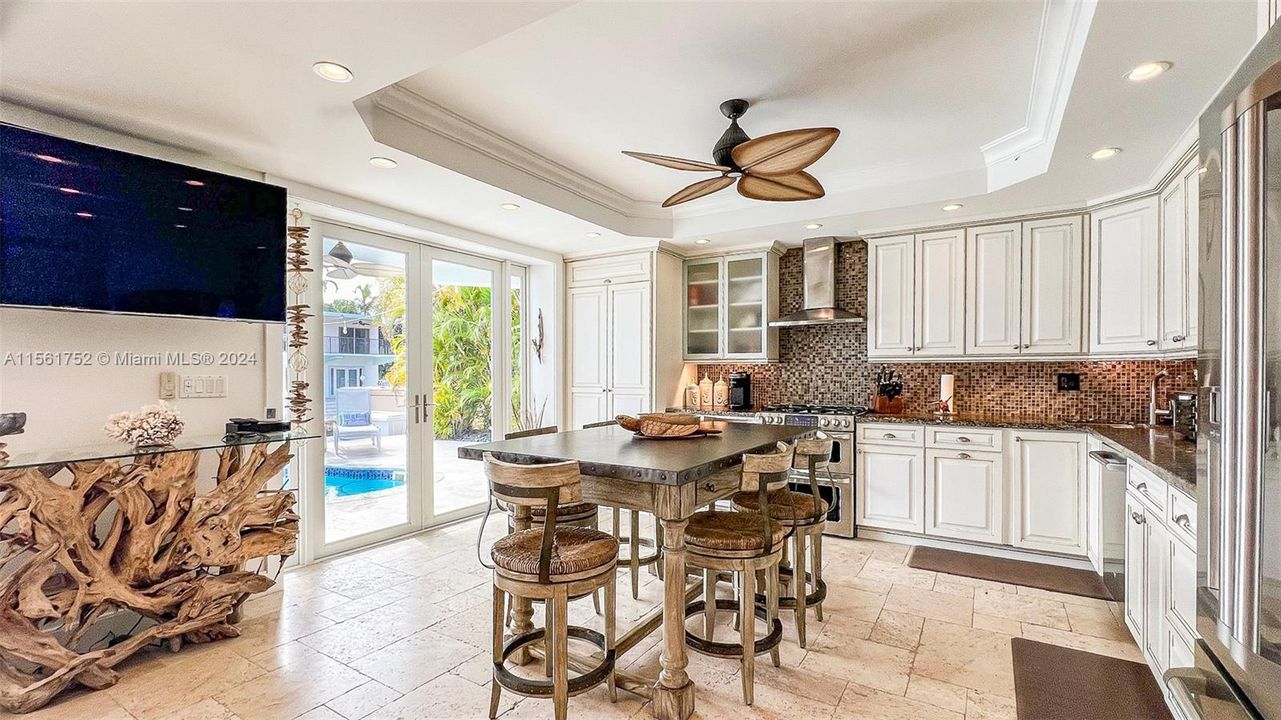 Flow effortlessly from culinary creations to relaxation in this open-concept kitchen and living area at 124 Bahama Road, where chic design meets comfort by the waterfront