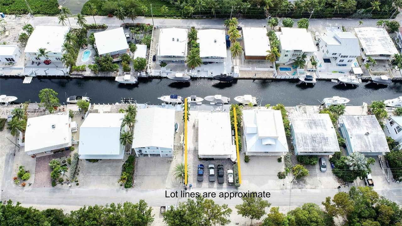 Get up close with the exclusive 124 Bahama Road, Key Largo, FL, highlighting its precise lot boundaries and showcasing the property's waterfront charm, complete with private docks and tropical ambiance