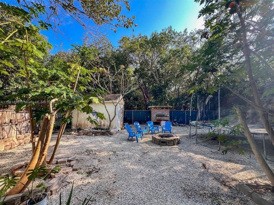 Your private oasis awaits—envision evenings by the fire pit and endless summer days in this spacious backyard at 130 Ocean View Drive, the perfect setting for making memories in the heart of Tavernier.