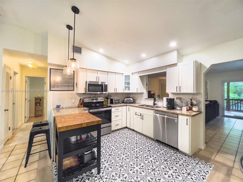 Craft your favorite dishes in this beautifully appointed kitchen, where the striking tile floor dances with light, creating a space that’s both functional and a feast for the eyes.