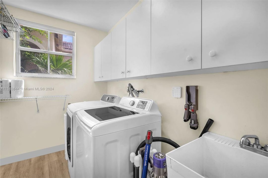 Laundry room with lots of storage and utility sink