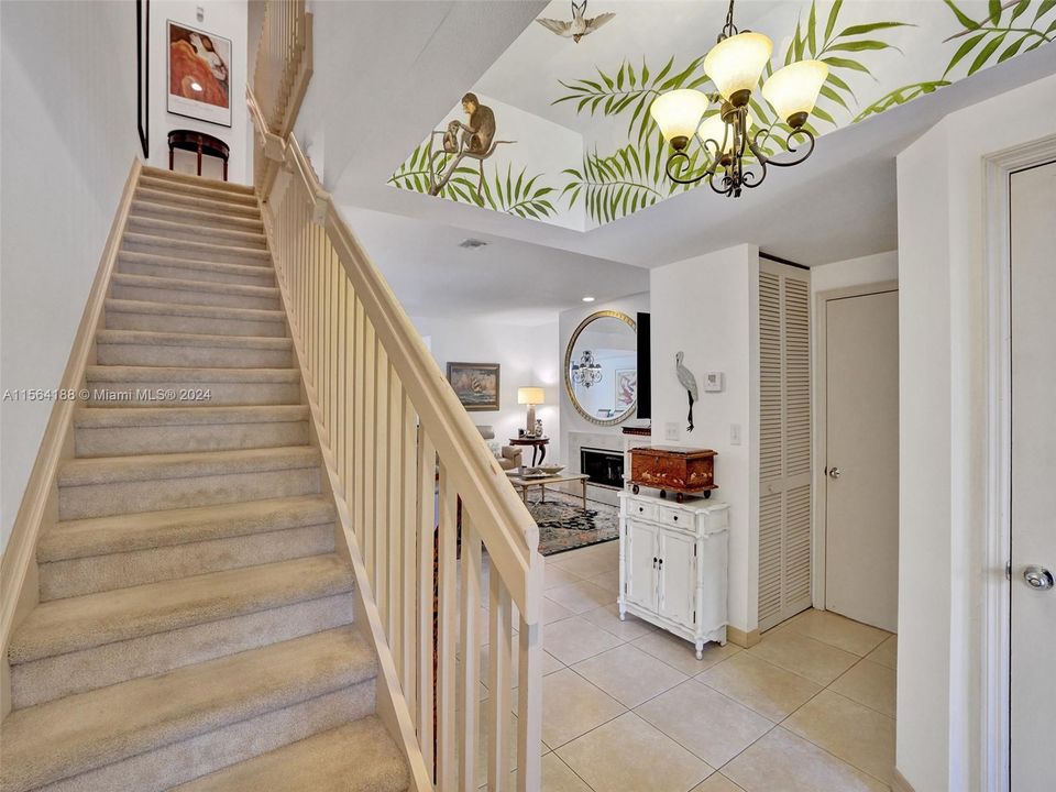 An inviting Palm Beach foyer to the living area & Stairwell to the bedrooms