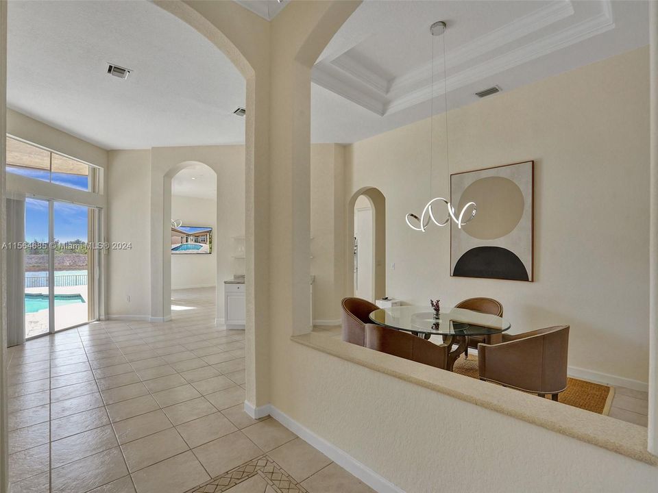 Grand foyer into open combination dining/family room