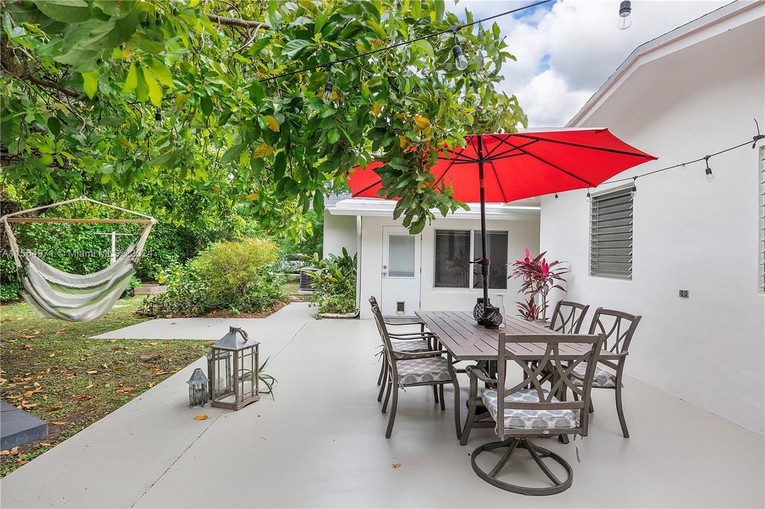 Beautiful patio featuring a large avocado tree, offering ample space to relax and entertain