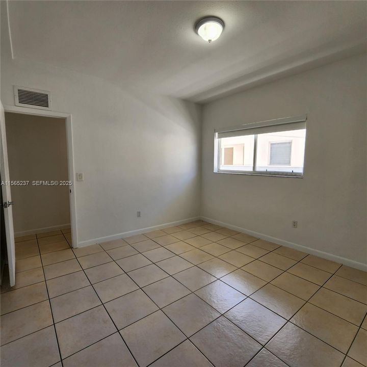 West facing window w/Exterior Accordian Hurricane Shutters