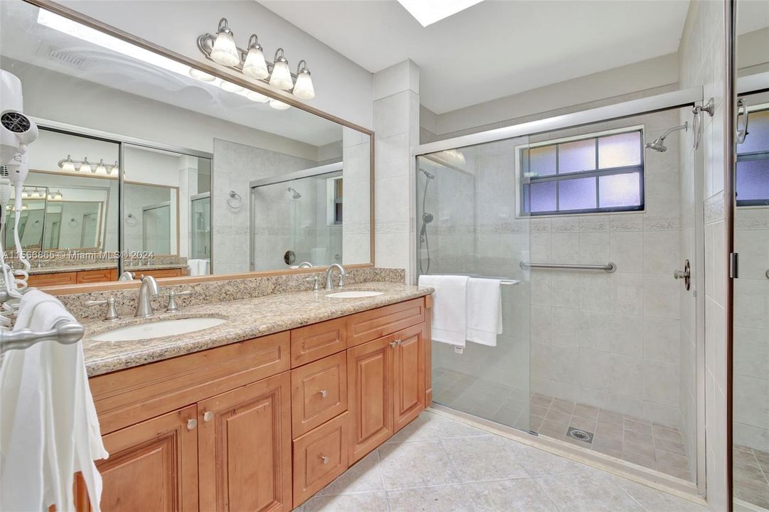 Primary Bathroom w/ dual vanity; real wood cabinets; walk in shower and walk in closet