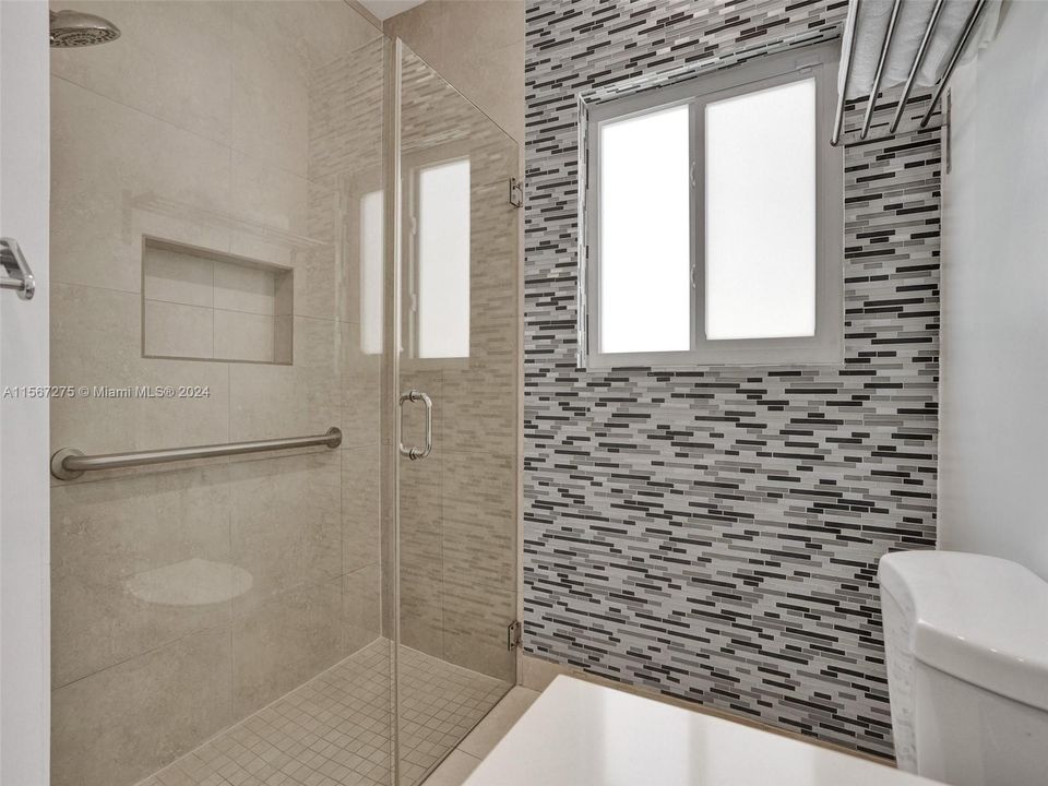 Fully tiled in shower add to the modern look of the home.