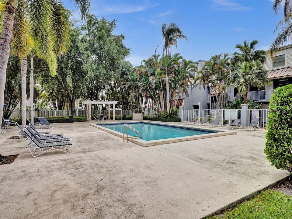 The gated pool area boasts a gazebo and outdoor kitchen